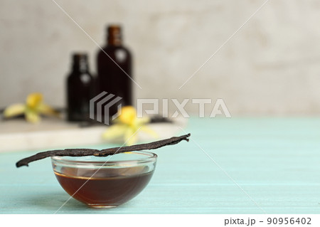 Aromatic homemade vanilla extract on light blue wooden table. Space for text Aromatic homemade vanilla extract on light blue wooden table. Space for text 90956402