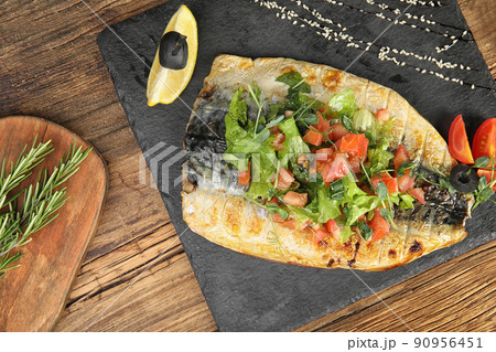 Delicious grilled fish served on wooden table, flat lay Delicious grilled fish served on wooden table, flat lay 90956451