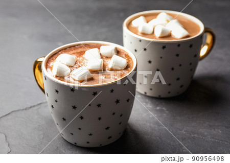 Cups of delicious hot cocoa with marshmallows on grey table Cups of delicious hot cocoa with marshmallows on grey table 90956498