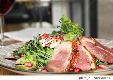 Delicious salad with roasted duck breast on plate, closeup Delicious salad with roasted duck breast on plate, closeup 90956673