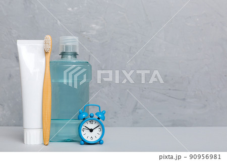 Mouthwash and other oral hygiene products on colored table top view with copy space. Flat lay. Dental hygiene. Oral care products and space for text on light background. concept Mouthwash and other oral hygiene products on colored table top view with copy space. Flat lay. Dental hygiene. Oral care products and space for text on light background. concept 90956981