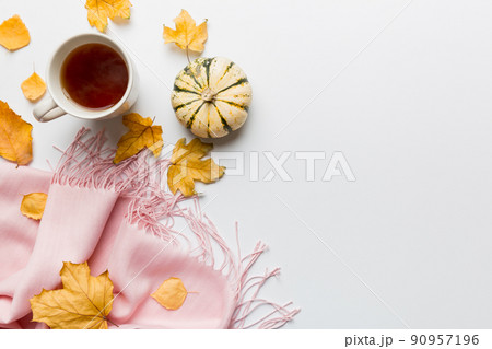 Flat lay composition with colorful Autumn cup of coffee and leaves on a color background. top view 90957196