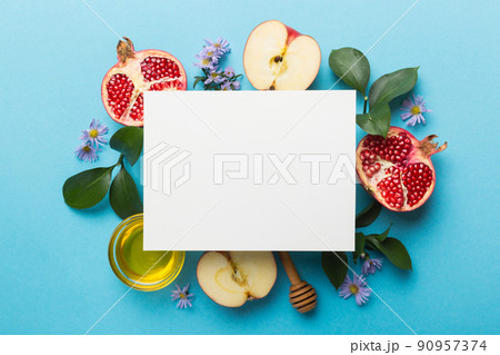 Flat lay composition with Blank flyer poster and symbols jewish Rosh Hashanah holiday attributes on colored background, New Year holiday Traditional. Top view with copy space mock up Flat lay composition with Blank flyer poster and symbols jewish Rosh Hashanah holiday attributes on colored background, New Year holiday Traditional. Top view with copy space mock up 90957374