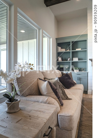 Wooden side table couch and cabinet inside the cozy living room of a home 90959209