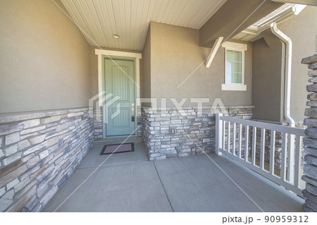 Mint green front door with blue lockbox and white half doorframe 90959312