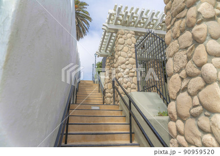 Concrete stairs with metal handrails in the middle of buildings at Carlsbad, San Diego, California 90959520