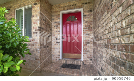 Pano Exterior of an entrance of house with red door, windows, plants and bricks Pano Exterior of an entrance of house with red door, windows, plants and bricks 90959746