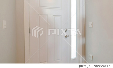 Panorama Interior of a white front door of a house with side glass panel Panorama Interior of a white front door of a house with side glass panel 90959847