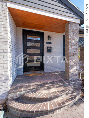 Vertical Exterior of a house with white bricks and stone bricks column posts and pavement Vertical Exterior of a house with white bricks and stone bricks column posts and pavement 90959929