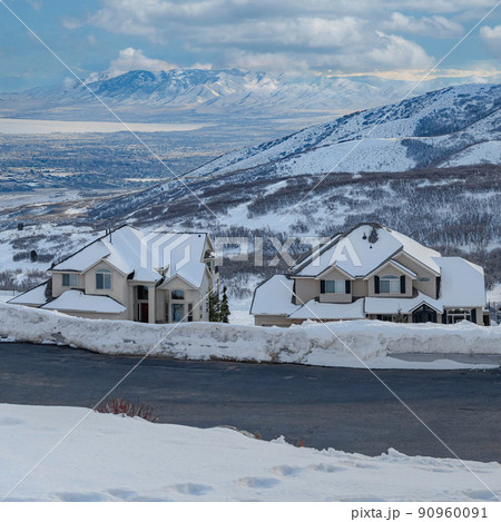 Square White puffy clouds Uphill snowy residential area at Draper in Utah with a view of W Square White puffy clouds Uphill snowy residential area at Draper in Utah with a view of W 90960091