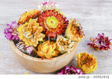 Dried straw flower heads on wooden background. Dried straw flower heads on wooden background. 90962838