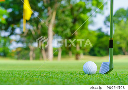Golf ball on green grass ready to be struck on golf course 90964508