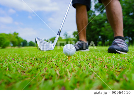 Golf ball on green grass ready to be struck on golf course Golf ball on green grass ready to be struck on golf course 90964510