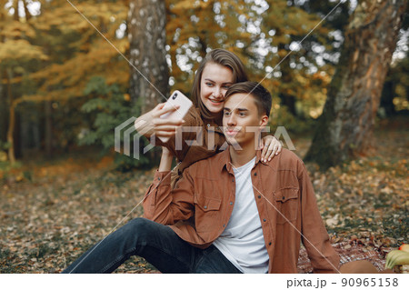 Beautiful couple spend time in a autumn park 90965158