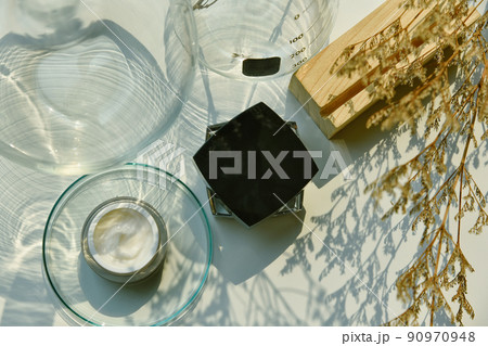 Cosmetic bottle container on sunlight and leaves plant shadow background, Skincare facial  90970948