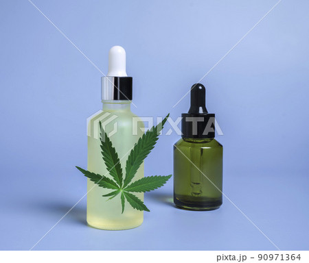 hemp cosmetic oil or serum, treatment for hair and scalp. Medical marijuana CBD oil and green leaf hemp cosmetic oil or serum, treatment for hair and scalp. Medical marijuana CBD oil and green leaf 90971364