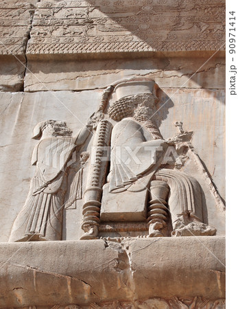 Bas-relief on ancient wall with of a king seated on a throne, Persepolis, Iran Bas-relief on ancient wall with of a king seated on a throne, Persepolis, Iran 90971414