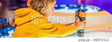 The boy plays with the electronic designer on the light table BANNER, LONG FORMAT 90972512