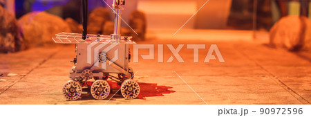 The boy controls the toy rover on Mars. Flight to Mars concept BANNER, LONG FORMAT The boy controls the toy rover on Mars. Flight to Mars concept BANNER, LONG FORMAT 90972596