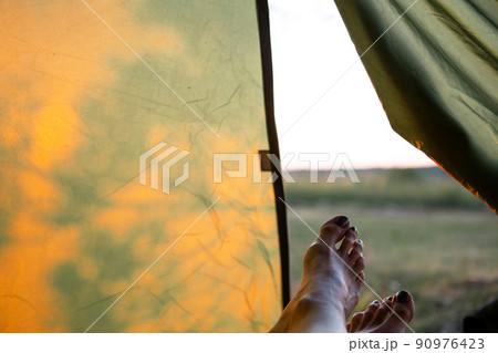 View from inside the tourist tent on a sunny day and nature. Active camping, environmental friendliness, adventure View from inside the tourist tent on a sunny day and nature. Active camping, environmental friendliness, adventure 90976423