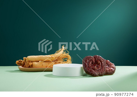 Front view of lingzhi mushroom and ginseng in brown background Front view of lingzhi mushroom and ginseng in brown background 90977274