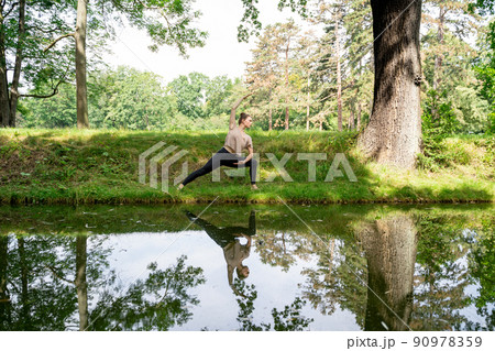 Young woman practicing yoga, pilates orの写真素材 [90978359