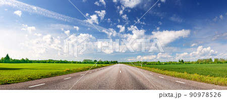 Panoramic view of the curve asphalt road in spring in nature. Panoramic view of the curve asphalt road in spring in nature. 90978526