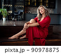 Beautiful adult woman sitting in the kitchen 90978875
