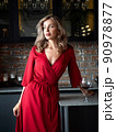 Beautiful adult woman standing in the kitchen 90978877