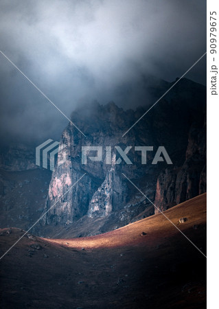 High mountain cliff with low clouds in Caucasus region in Russia 90979675