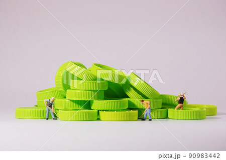 Worker figure standing on plastic cap. Recycle material concept. Worker figure standing on plastic cap. Recycle material concept. 90983442