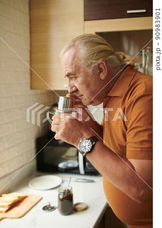 Senior Man Smelling Ground Coffee Senior Man Smelling Ground Coffee 90983901