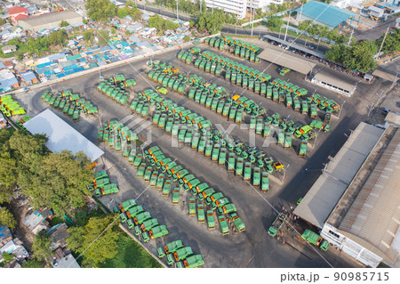 Aerial view of trash garbage tractor truck cars in industrial factory in environmental pollution. Waste disposal in dumping site. Aerial view of trash garbage tractor truck cars in industrial factory in environmental pollution. Waste disposal in dumping site. 90985715