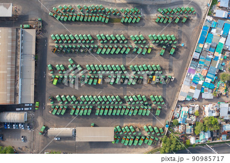 Aerial view of trash garbage tractor truck cars in industrial factory in environmental pollution. Waste disposal in dumping site. Aerial view of trash garbage tractor truck cars in industrial factory in environmental pollution. Waste disposal in dumping site. 90985717