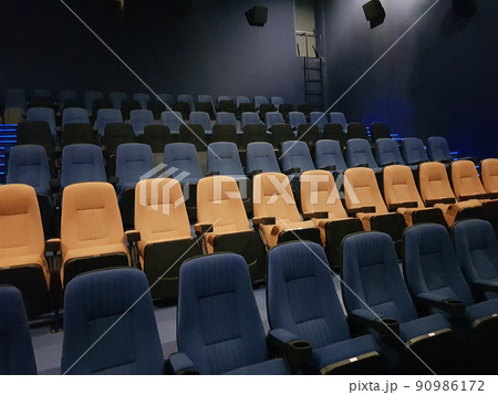 Empty row line of blue and orange seats in the cinema hall Empty row line of blue and orange seats in the cinema hall 90986172