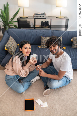 Young couple spending time at home and looking enjoyed Young couple spending time at home and looking enjoyed 90987072