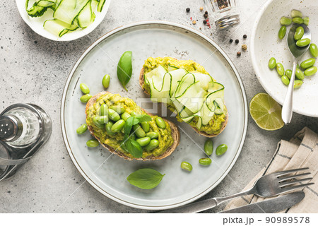 Healthy avocado toasts with different toppings 90989578
