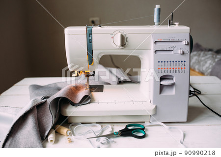 Sewing machine, accessories and fabric. Cozy creative sewing process at home 90990218