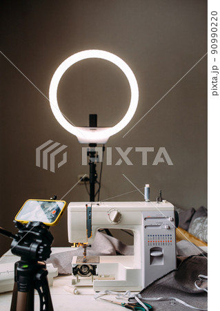 Shooting video of the sewing process, workshop on clothing design on smartphone 90990220