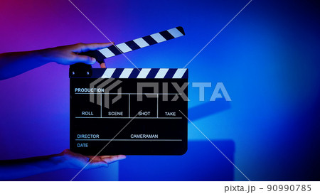 Movie Clapper board. Crew hand holding plastic and wooden film slate board against camera. Movie clapperboard using in video production and movie studio works film industry. Film slate on crew hand. 90990785