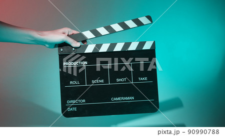 Movie Clapper board. Crew hand holding plastic and wooden film slate board against camera. Movie clapperboard using in video production and movie studio works film industry. Film slate on crew hand. 90990788