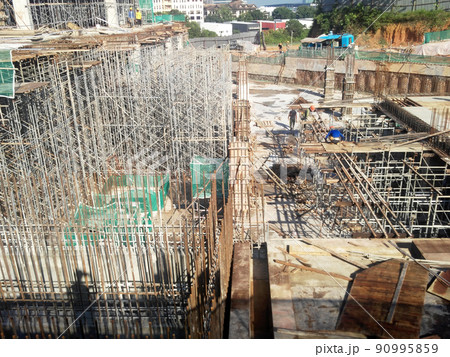 SELANGOR, MALAYSIA -JULY 6, 2021: Construction workers are carrying out daily routines and housekeeping work at a construction site. They are required to wear safety equipment on site. SELANGOR, MALAYSIA -JULY 6, 2021: Construction workers are carrying out daily routines and housekeeping work at a construction site. They are required to wear safety equipment on site. 90995859