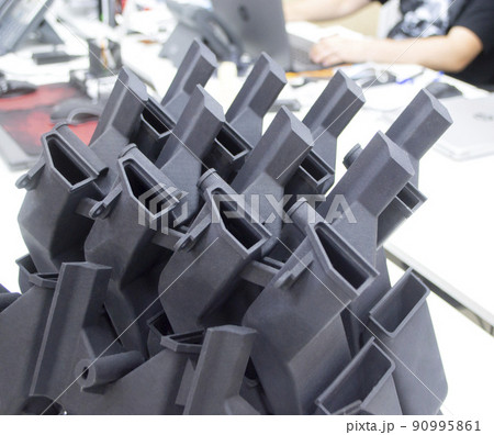 Black model printed on 3D printer in laboratory office. Object printed on 3D printer from plastic close-up. Prototype made on 3d printer. Concept new modern printing technology. Multi Jet Fusion 90995861
