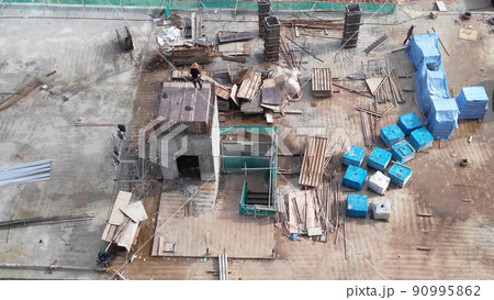 SELANGOR, MALAYSIA -JULY 6, 2021: Construction workers are carrying out daily routines and housekeeping work at a construction site. They are required to wear safety equipment on site. SELANGOR, MALAYSIA -JULY 6, 2021: Construction workers are carrying out daily routines and housekeeping work at a construction site. They are required to wear safety equipment on site. 90995862