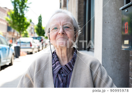 Portrait of a cheerful 83 year old white grandmother in the streets 90995978