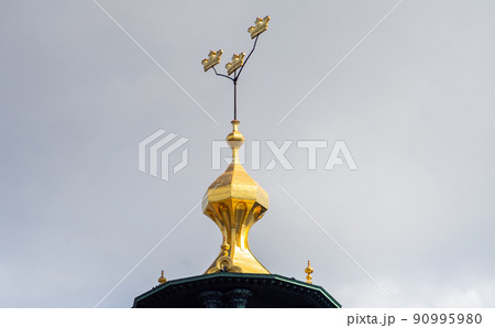 Three crowns - a symbol of Sweden on the dome of a building in Stockholm. 90995980