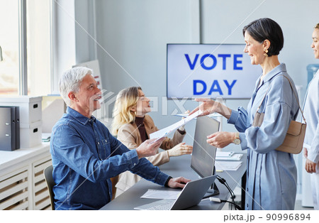 Smiling People at Voting Station Side View 90996894