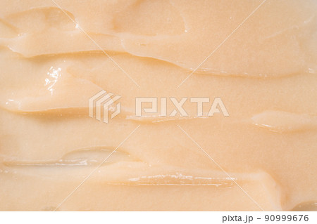 Hair conditioner cream background. Yellow cosmetic lotion moisturiser sample closeup. Body care balm, retinol serum, shampoo wavy texture. Skincare mask smear, creamy cleanser product 90999676