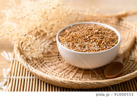 Golden flax seed or linseed in bowl Golden flax seed or linseed in bowl 91000553