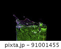 Water splashed from the mouth of the green glass. 91001455